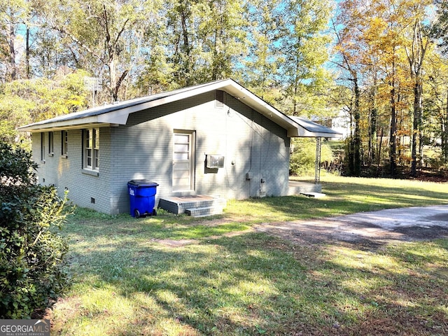 view of side of home featuring a yard