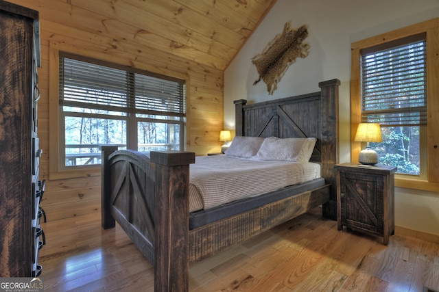 bedroom with wooden ceiling, multiple windows, light wood-type flooring, and lofted ceiling