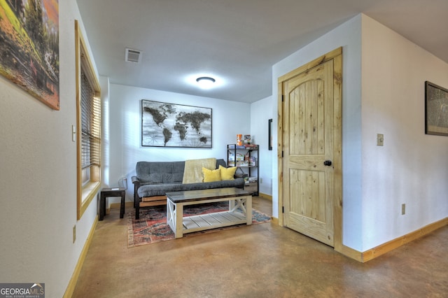 sitting room featuring concrete floors