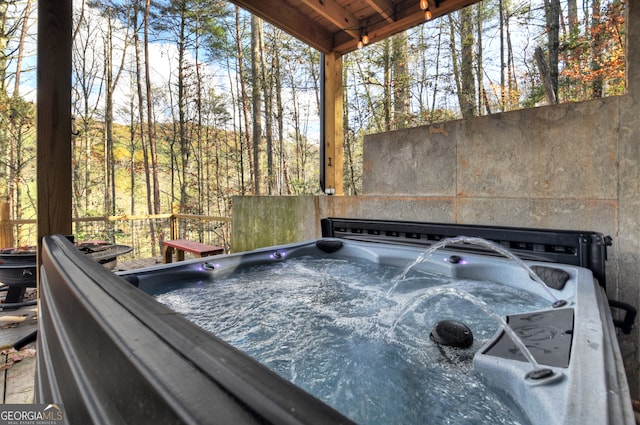 wooden terrace with a hot tub