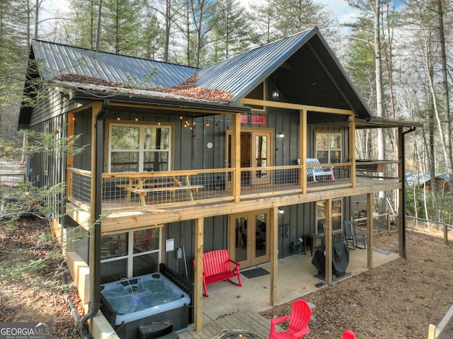 rear view of property featuring french doors and a patio