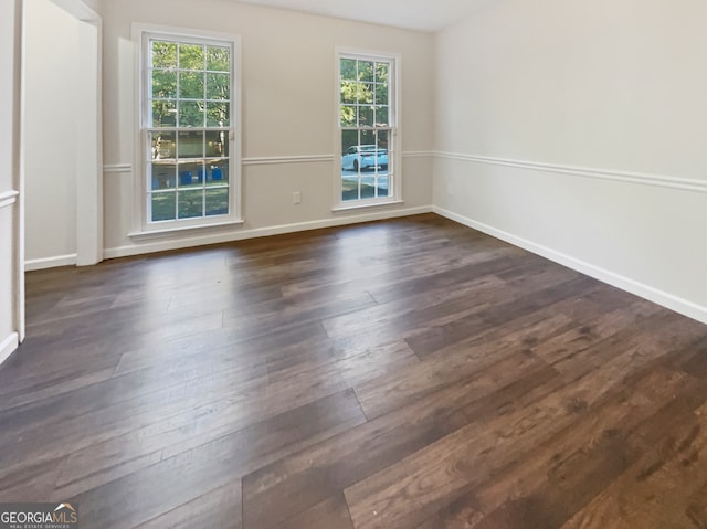 spare room with dark hardwood / wood-style floors