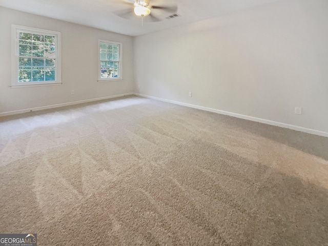 empty room with ceiling fan and carpet flooring