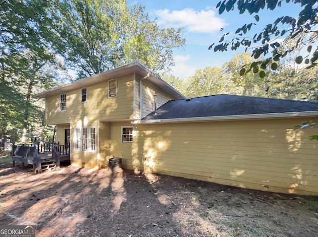 back of property featuring a wooden deck