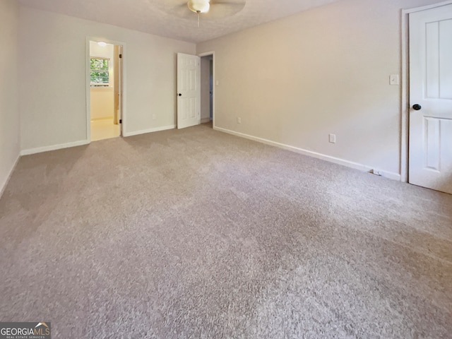 unfurnished room with ceiling fan and carpet floors