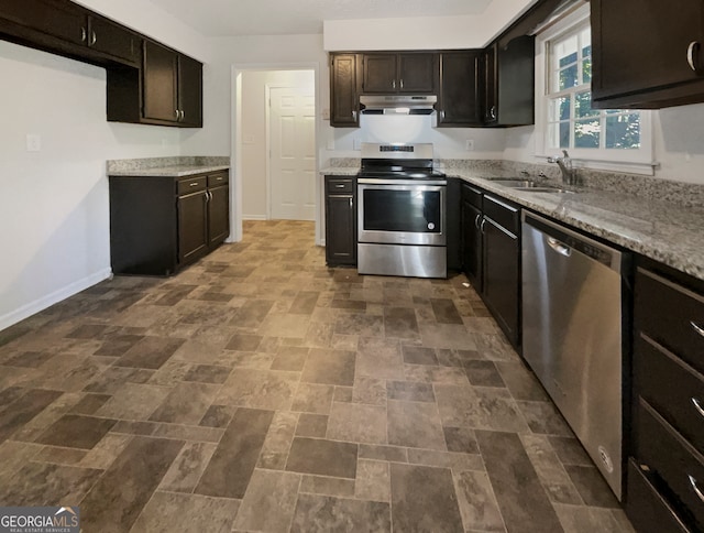 kitchen featuring dark brown cabinetry, stainless steel appliances, sink, and light stone counters