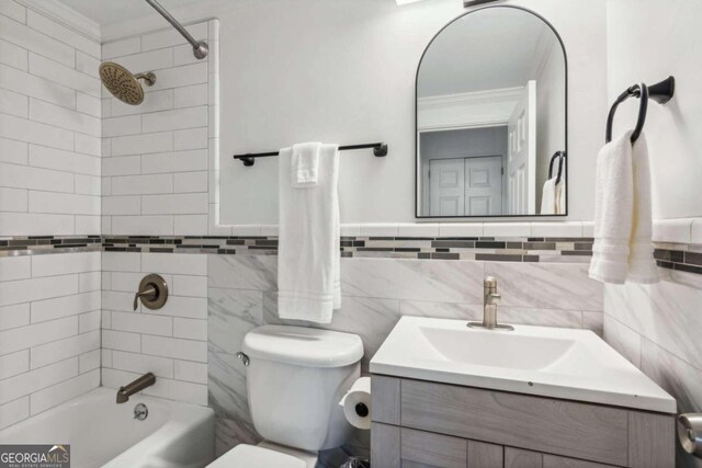 full bathroom featuring ornamental molding, tile walls, and toilet