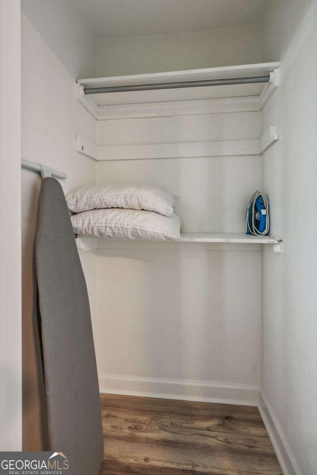 walk in closet featuring dark hardwood / wood-style flooring