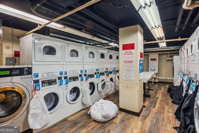 laundry area with dark wood-type flooring, stacked washer / dryer, and independent washer and dryer