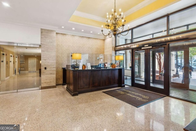 reception area with french doors and a notable chandelier