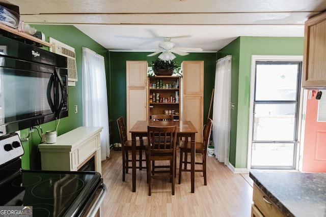 dining area with light wood-type flooring and ceiling fan