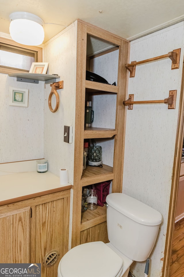 bathroom featuring hardwood / wood-style flooring and toilet