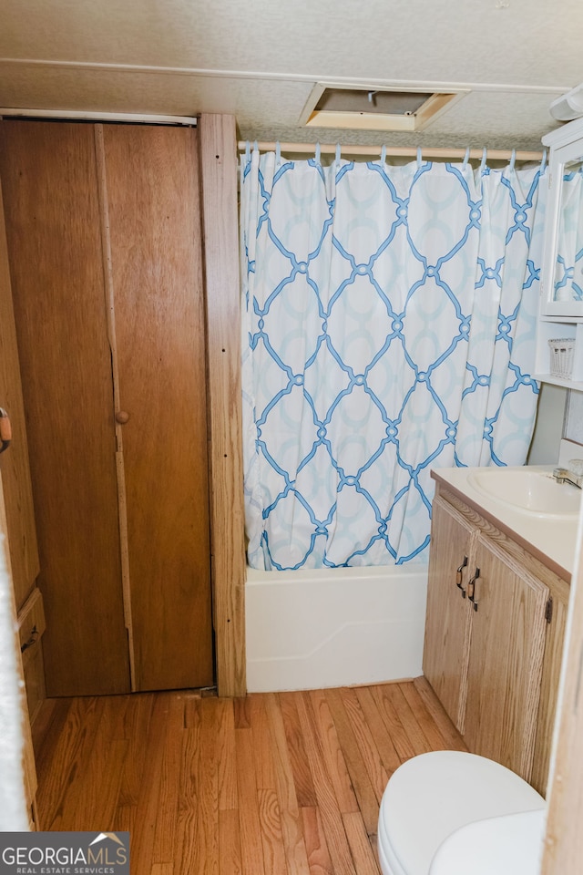 full bathroom featuring toilet, vanity, shower / bath combo, and hardwood / wood-style flooring