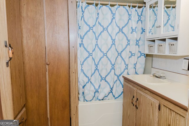 bathroom featuring shower / bath combination with curtain and vanity