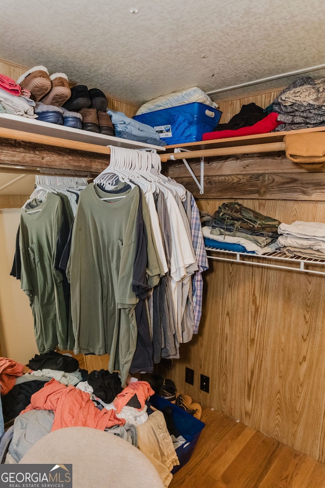 walk in closet with hardwood / wood-style floors