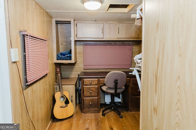 home office featuring wood walls and light wood-type flooring