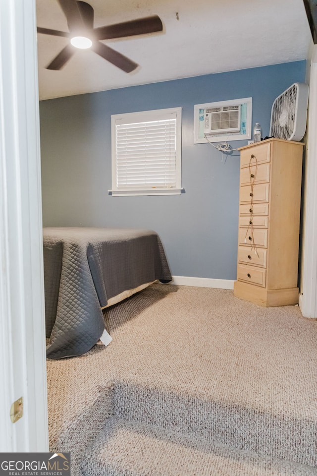 bedroom with carpet flooring, ceiling fan, and a wall unit AC