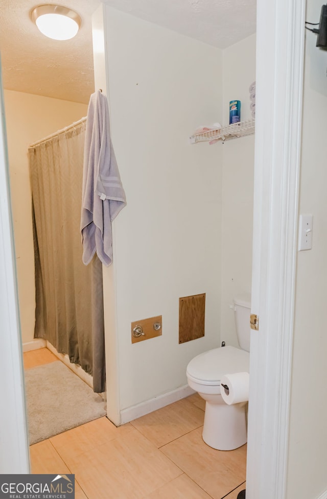 bathroom featuring walk in shower and toilet