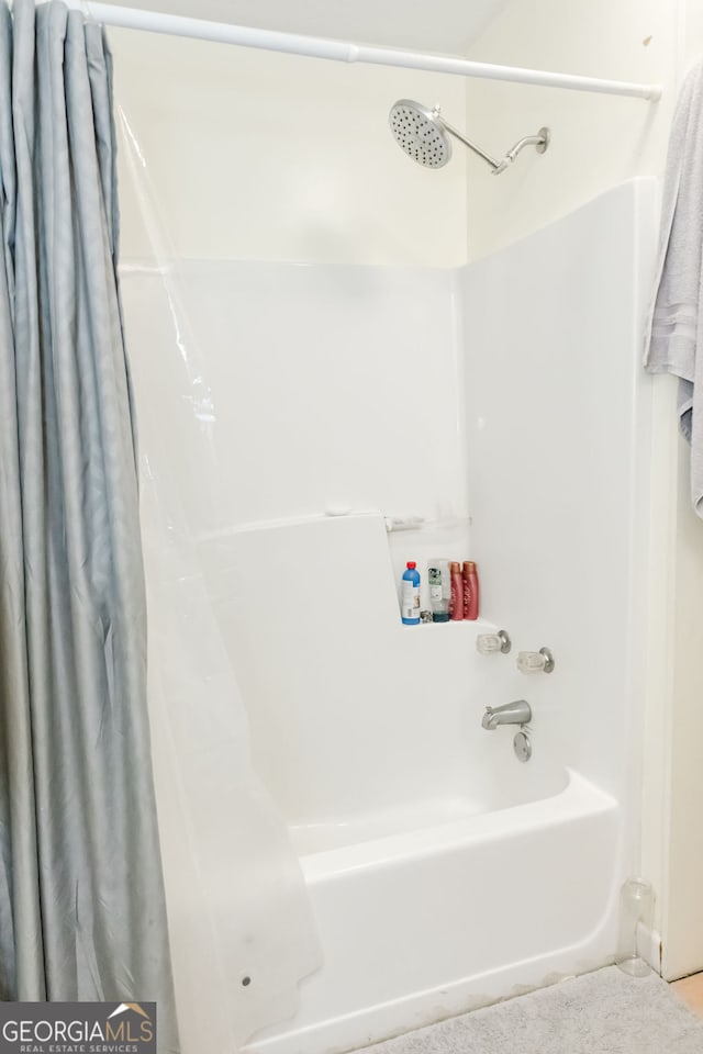 bathroom featuring shower / tub combo with curtain