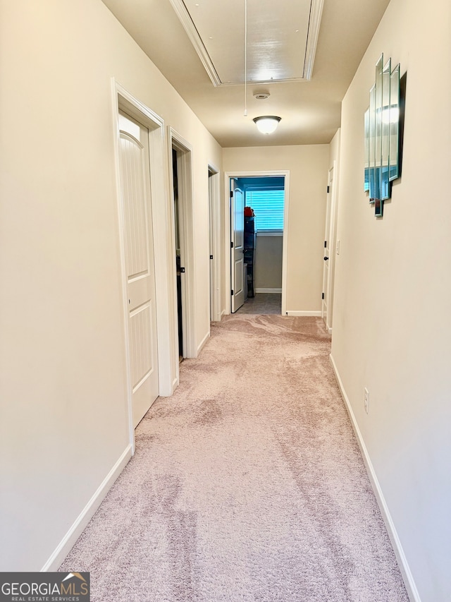 hallway with light colored carpet