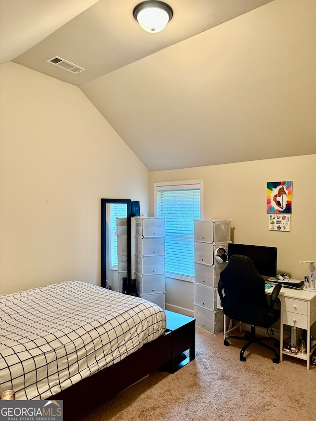 carpeted bedroom featuring lofted ceiling