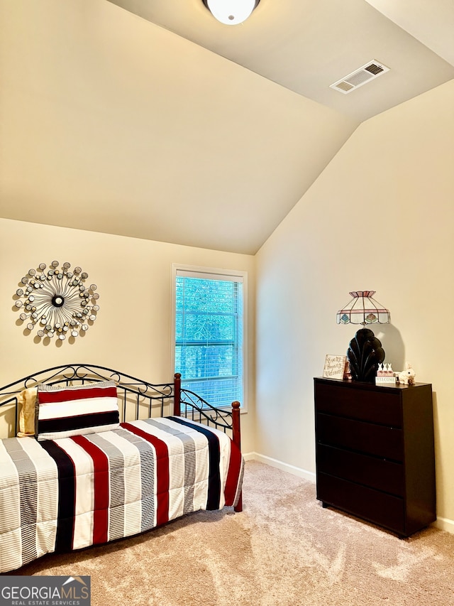 carpeted bedroom featuring vaulted ceiling