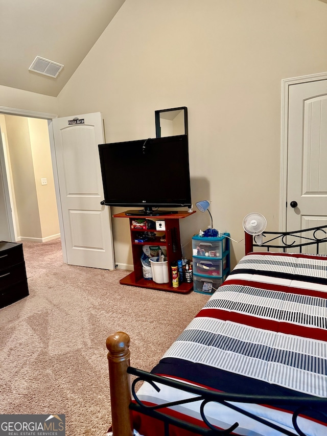 carpeted bedroom with vaulted ceiling