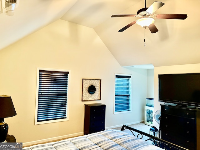 carpeted bedroom featuring ceiling fan and vaulted ceiling