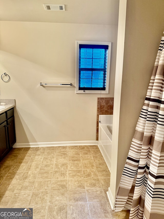 bathroom featuring a bath and vanity