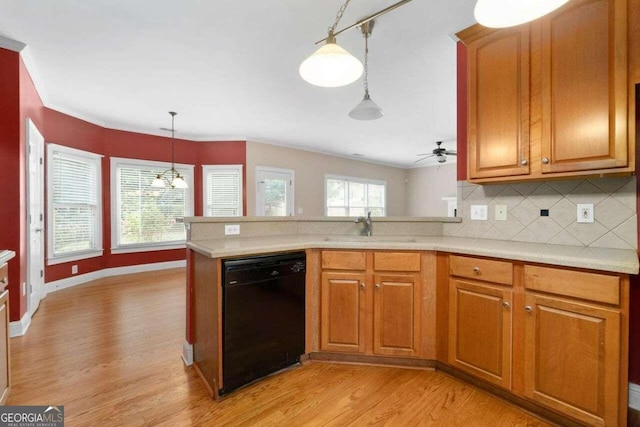 kitchen with light hardwood / wood-style floors, dishwasher, decorative backsplash, kitchen peninsula, and decorative light fixtures