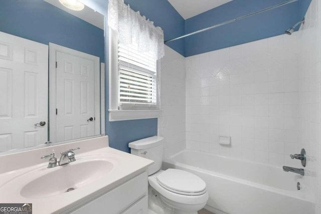 full bathroom featuring toilet, vanity, and tiled shower / bath