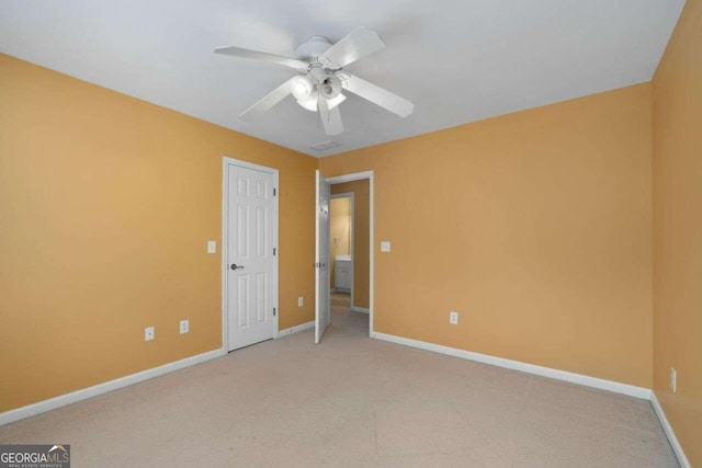 spare room featuring ceiling fan and light colored carpet