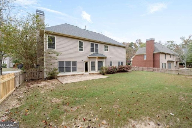 back of house featuring a patio and a lawn