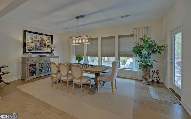 dining room with a wealth of natural light and light hardwood / wood-style flooring