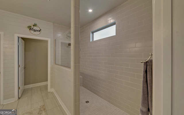 bathroom featuring tiled shower and tile patterned floors