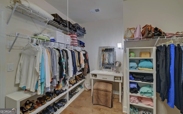 walk in closet with light wood-type flooring