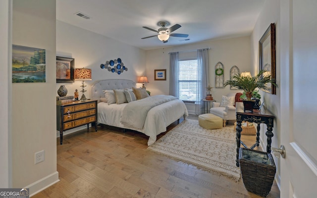 bedroom with light hardwood / wood-style flooring and ceiling fan