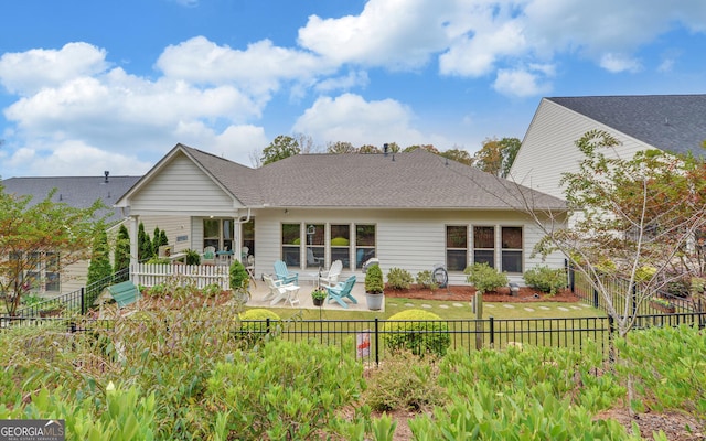 rear view of house featuring a yard and a patio area