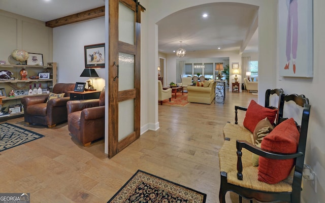 living room with light wood-type flooring and a chandelier