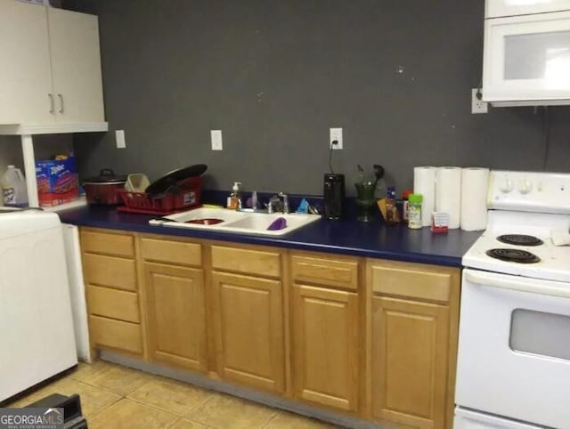 kitchen featuring white appliances, washer / dryer, sink, and light tile patterned flooring