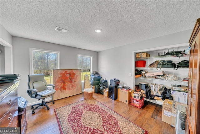 office space featuring a textured ceiling and hardwood / wood-style flooring