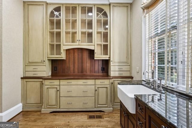 kitchen featuring cream cabinets, plenty of natural light, and light wood-type flooring