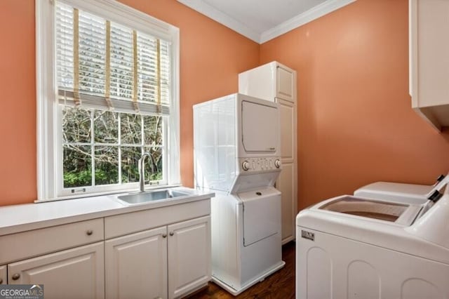 laundry area with sink, cabinets, stacked washing maching and dryer, dark hardwood / wood-style flooring, and ornamental molding