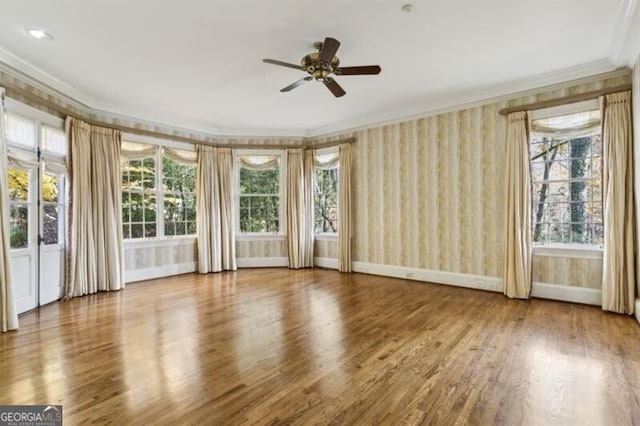 unfurnished room featuring wood-type flooring, ceiling fan, and ornamental molding