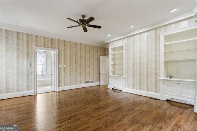 spare room with built in shelves, hardwood / wood-style flooring, ceiling fan, and ornamental molding