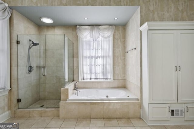 bathroom with tile patterned flooring and independent shower and bath