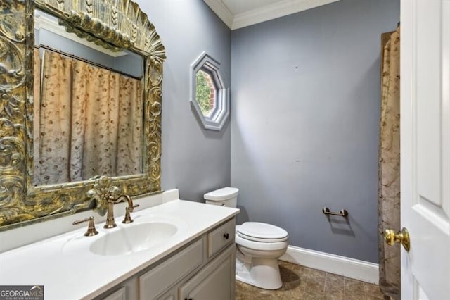 bathroom featuring vanity, toilet, and crown molding