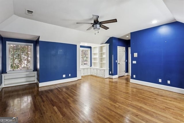 unfurnished living room with ceiling fan, wood-type flooring, and lofted ceiling