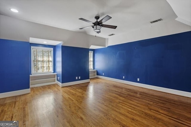 spare room featuring wood-type flooring and ceiling fan