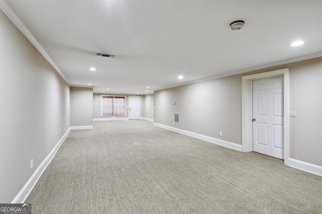 basement with light colored carpet and crown molding